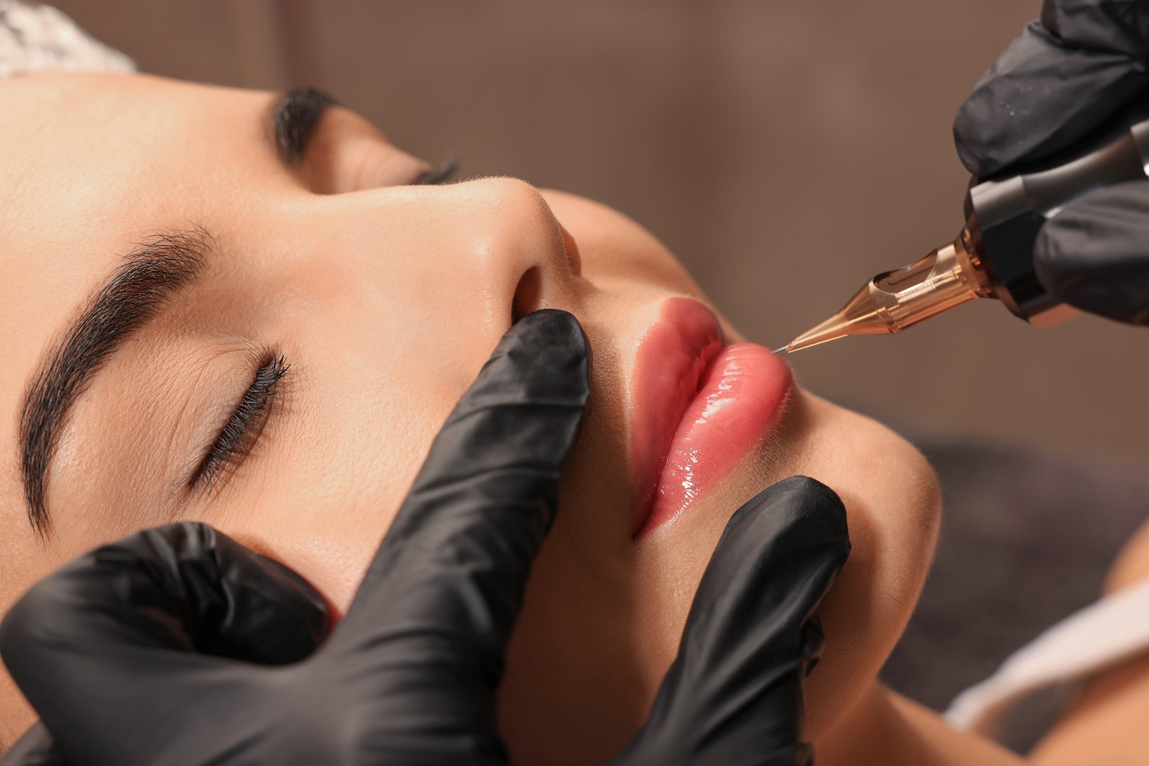 Young Woman Undergoing Procedure of Permanent Lip Makeup in Tatt